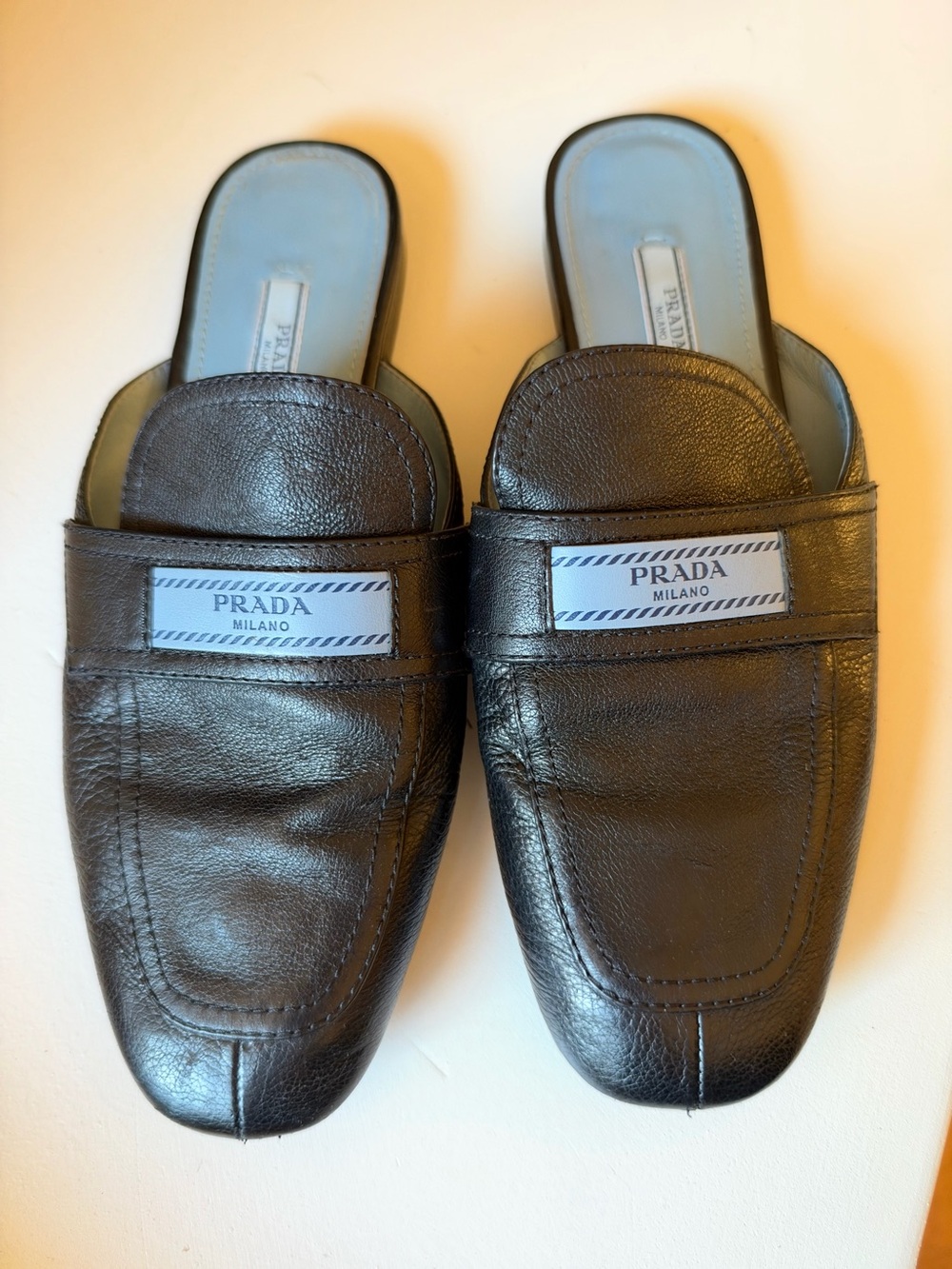 Prada Black Leather Slip-On Mules with Logo Plaque